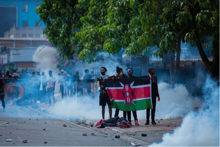 Gen Z protester holds the Kenyan flag during demonstrations following the fatal shooting of a fellow youth by police. 