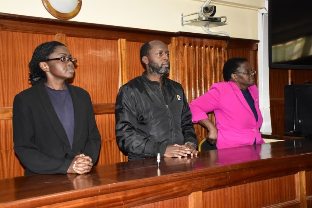 politician Rose Mbithe Mulwa (far right, in the pink jacket) and her two children, advocates Angela Mulwa (far left, in the black suit) and Chris Mulwa (center, in the black bomber jacket)