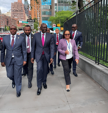 Kenyan delegation walking on a New York sidewalk during UNGA, sparking debate by Sifuna and Geoffrey Mosiria over local infrastructure.