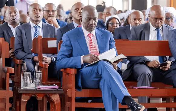 President Ruto seated in church reading a Bible amidst remarks from the Jubilee Party.