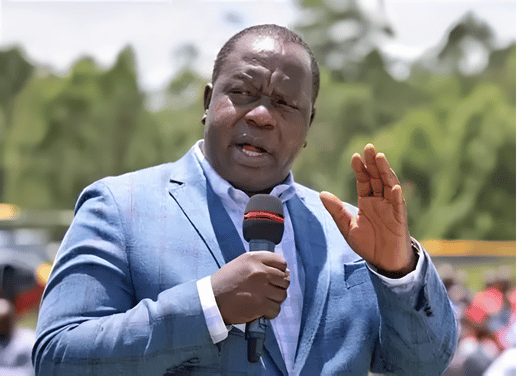 Former Interior Cabinet Secretary Fred Matiang’i addressing a crowd with a microphone.