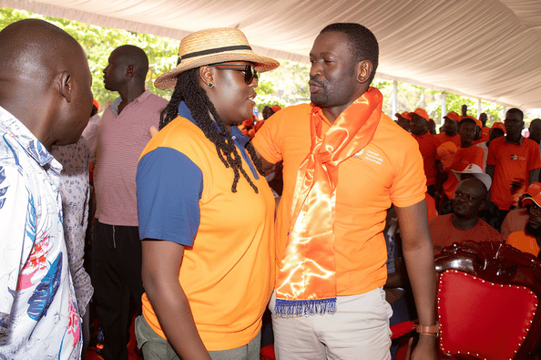 EALA MP Winnie Odinga clad in an ODM t-shirt and hat engages in a close conversation with Secretary General Edwin Sifuna during a party gathering.