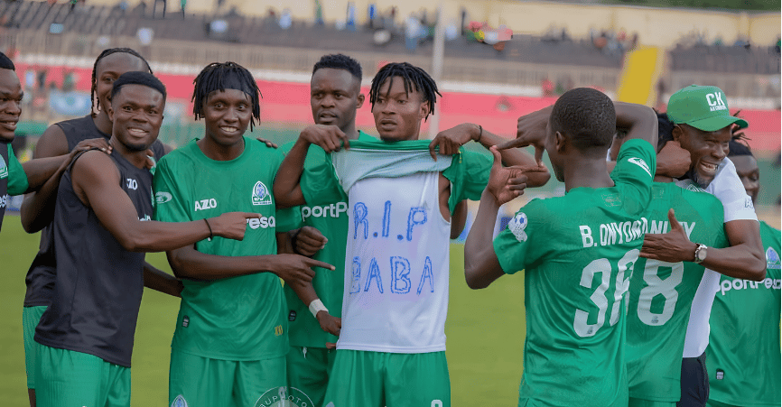 Gor Mahia FC players celebrating on the pitch with a vest displaying R.I.P BABA in honor of Raila Odinga