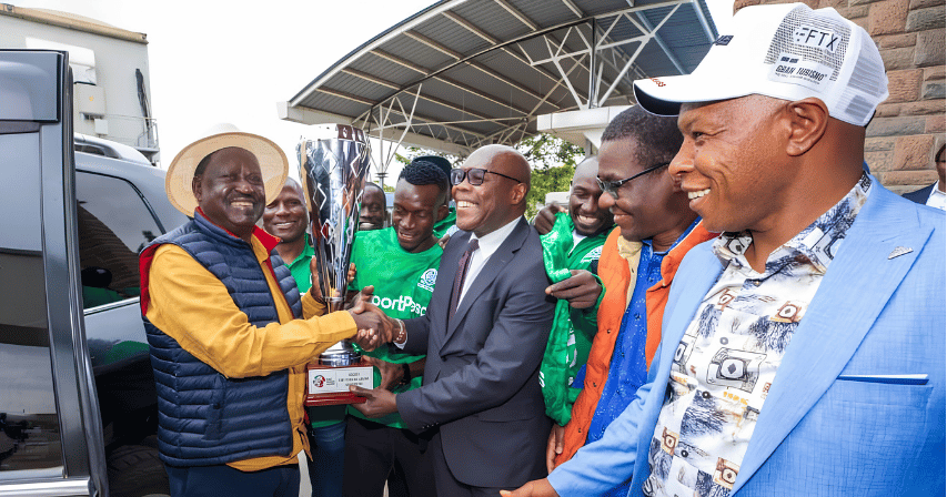 Raila Odinga receiving a trophy alongside Gor Mahia FC officials and players