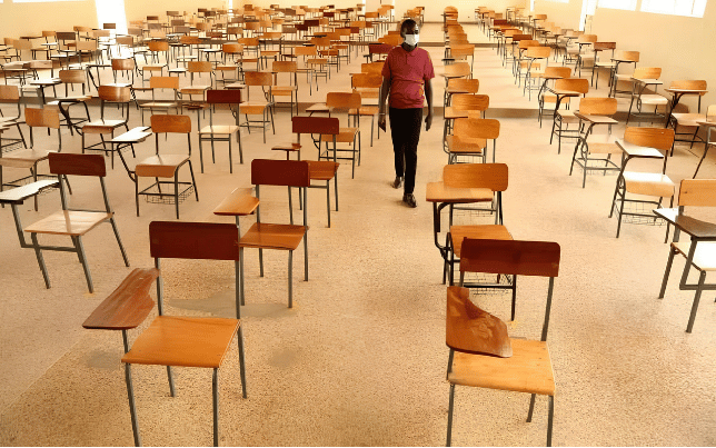 An empty university lecture hall showing rows of vacant desks amidst nationwide industrial action by striking university lecturers.