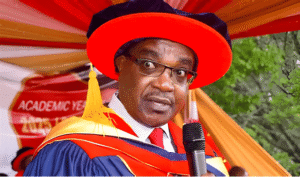 Education Cabinet Secretary Julius Ogamba speaking into a microphone during an official event, addressing issues surrounding striking university lecturers.
