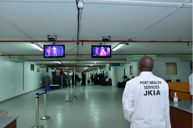 Port Health Services officer at JKIA monitoring thermal scanners for Ebola symptoms and high fever among passengers